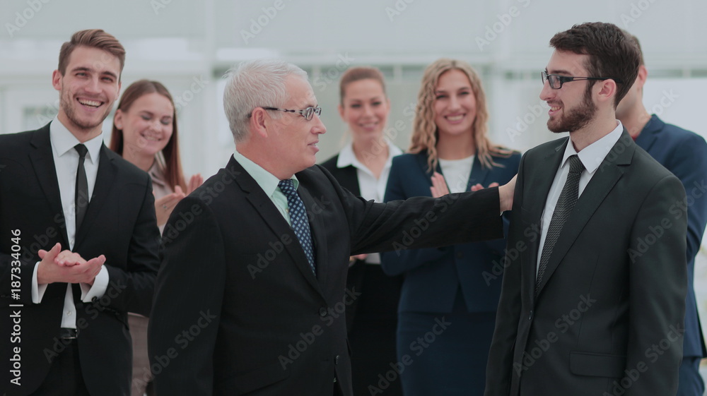 Mature businessman praising coworker during a meeting Mature businessman praising coworker during a meeting