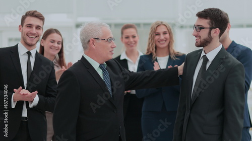 Mature businessman praising coworker during a meeting