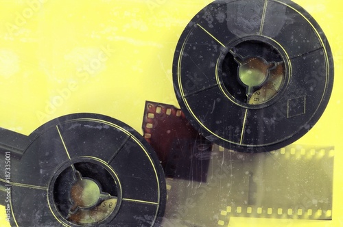 Film and film reel on yellow background.