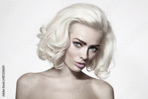 Vintage style portrait of young beautiful woman with platinum blonde hair and fresh make-up