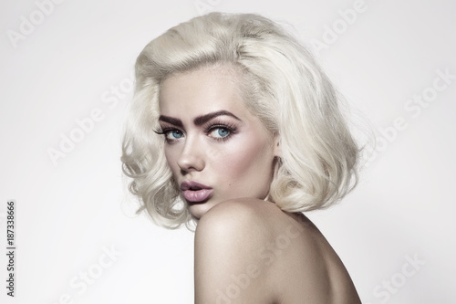 Vintage style portrait of young beautiful woman with platinum blonde hair and fresh make-up