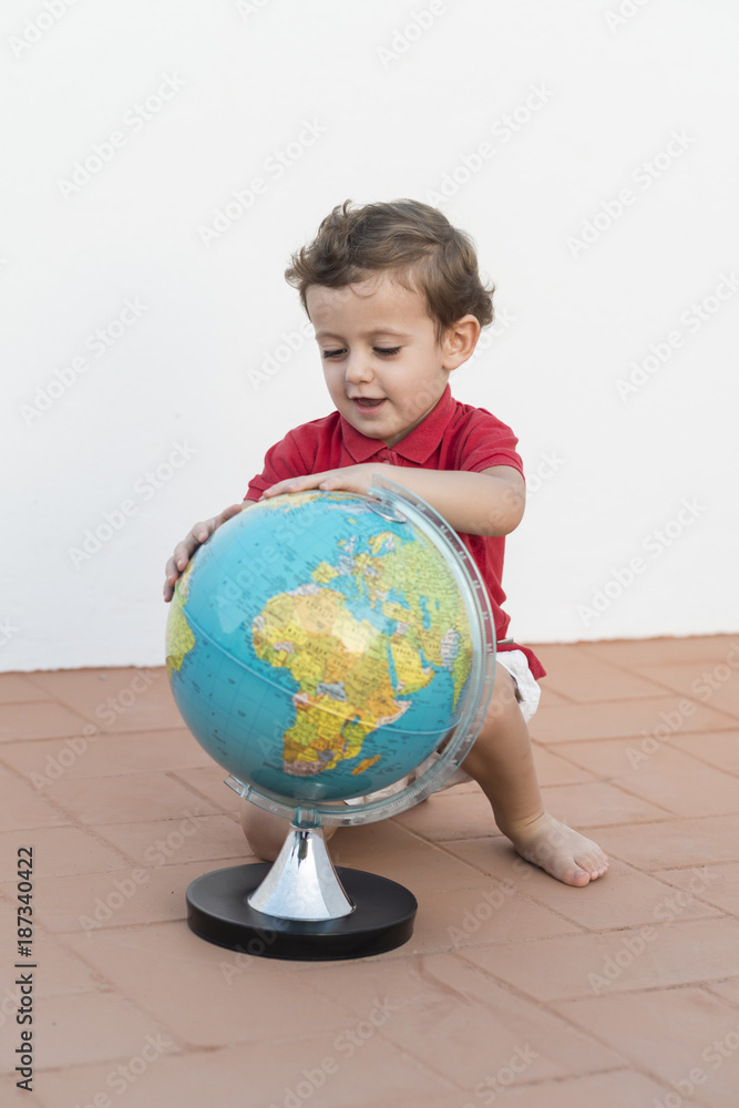 Child playing with a globe Child playing with a globe