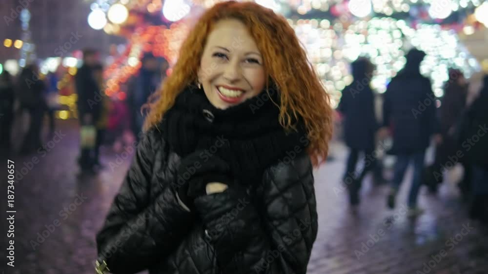 Happy smiling curly red hair walking and have a fun at winter fair city center Happy smiling curly red hair walking and have a fun at winter fair city center
