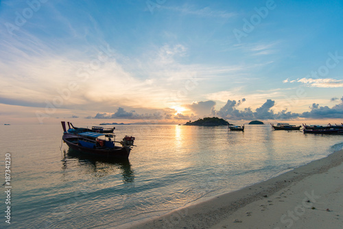 Sunrise at the beach with longtail boats at the tropical beach, Andaman Sea, Thailand