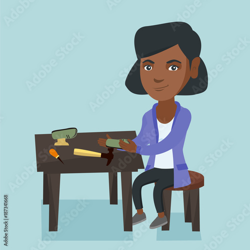 African-american shoemaker repairing a shoe in the workshop. Young shoemaker making handmade shoes in the workshop. Shoemaker working in the workshop. Vector cartoon illustration. Square layout.