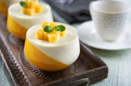 Panna cotta dessert  on a wooden board and coffee mug