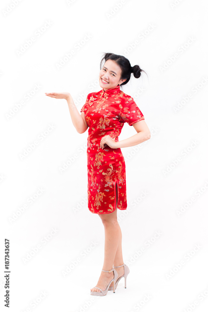 Young asian woman wearing chinese dress traditional cheongsam with gesture of congratulation, Looking at the camera and smile in Chinese New Year Festivities, New Year Celebration on white background. Young asian woman wearing chinese dress traditional cheongsam with gesture of congratulation, Looking at the camera and smile in Chinese New Year Festivities, New Year Celebration on white background.
