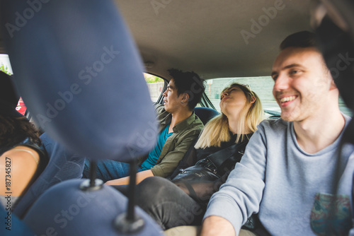 group of friends multiethnic travelling by car having fun - journey, travelling, weekend activities concept