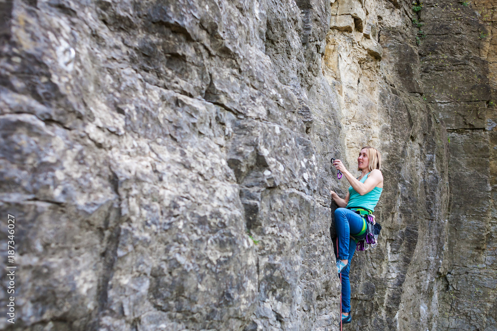 Fototapeta premium A woman climber on a rock.