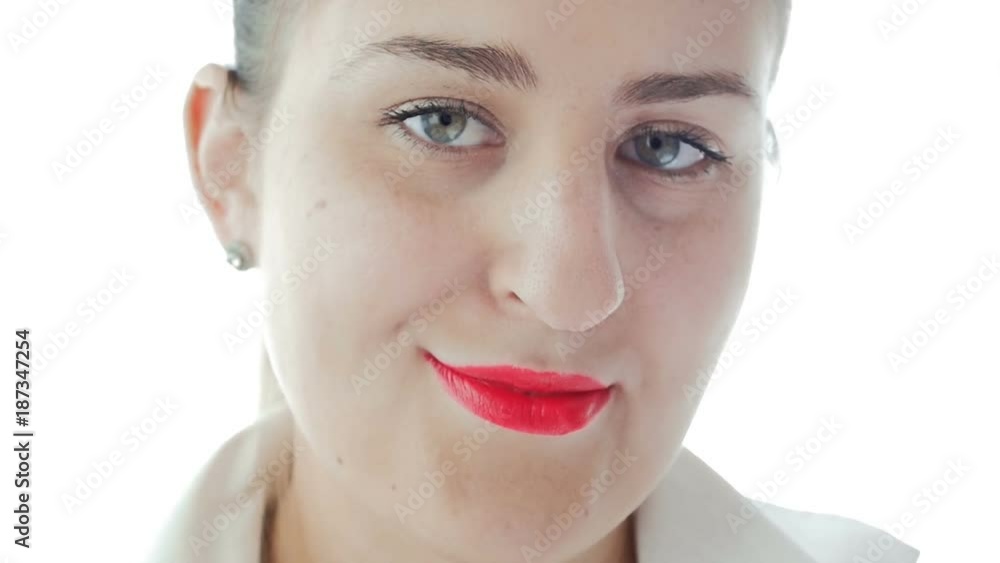 Closeup slow motion video of beeautiful young woman with red lipstick smiling in camera Closeup slow motion video of beeautiful young woman with red lipstick smiling in camera