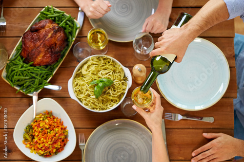 group of people eating and drinking wine