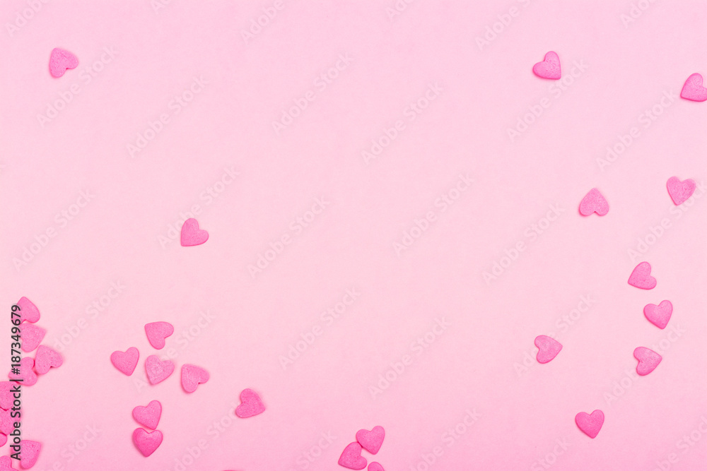 Pink heart shaped sprinkles on pink Valentines day background