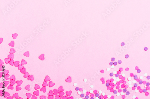 Pink heart shaped sprinkles on pink Valentines day background © happy_lark