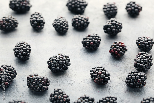 Ripe and sweet blackberries on grey wooden table