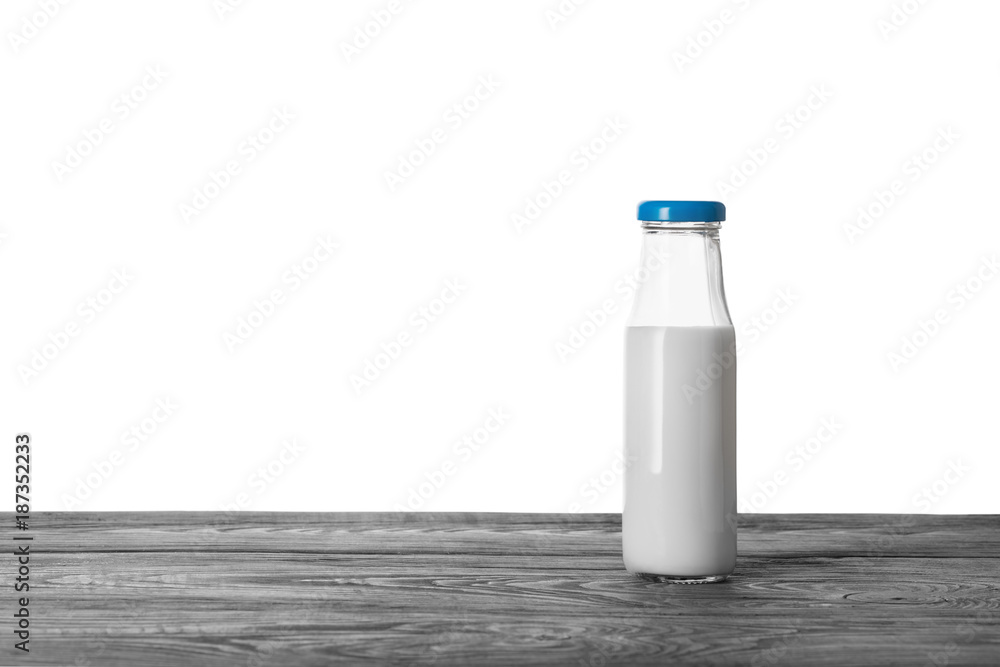 Bottle of milk on wooden table Bottle of milk on wooden table