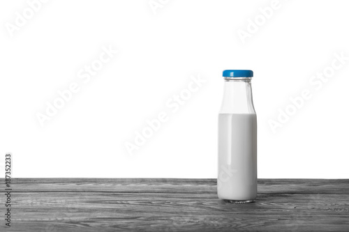 Bottle of milk on wooden table
