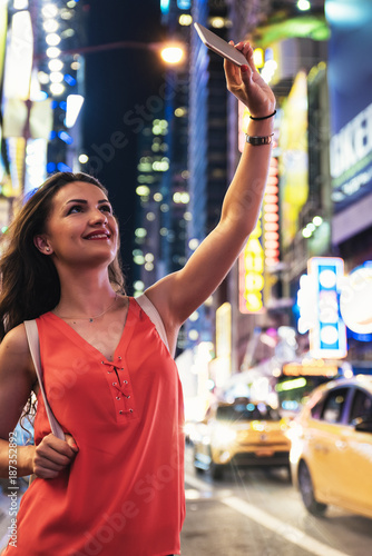 Beautiful woman using phone in Times Square.