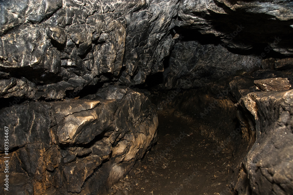 View inside a deep cave. The dark abyss.