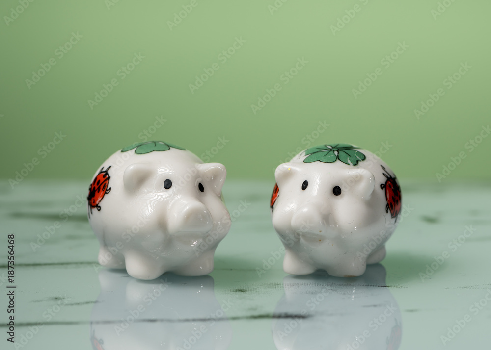 Figurine of two small white porcelain piggies Figurine of two small white porcelain piggies