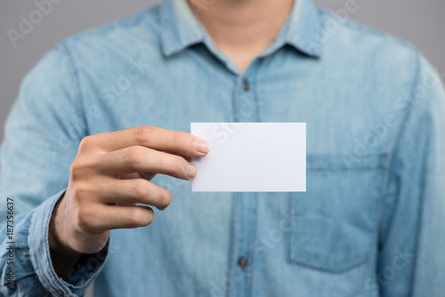 Cropped image of a man holding white business card