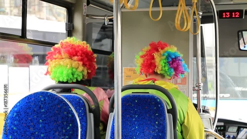 two clowns riding in a bus