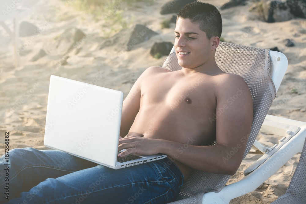 Young relaxed male with laptop