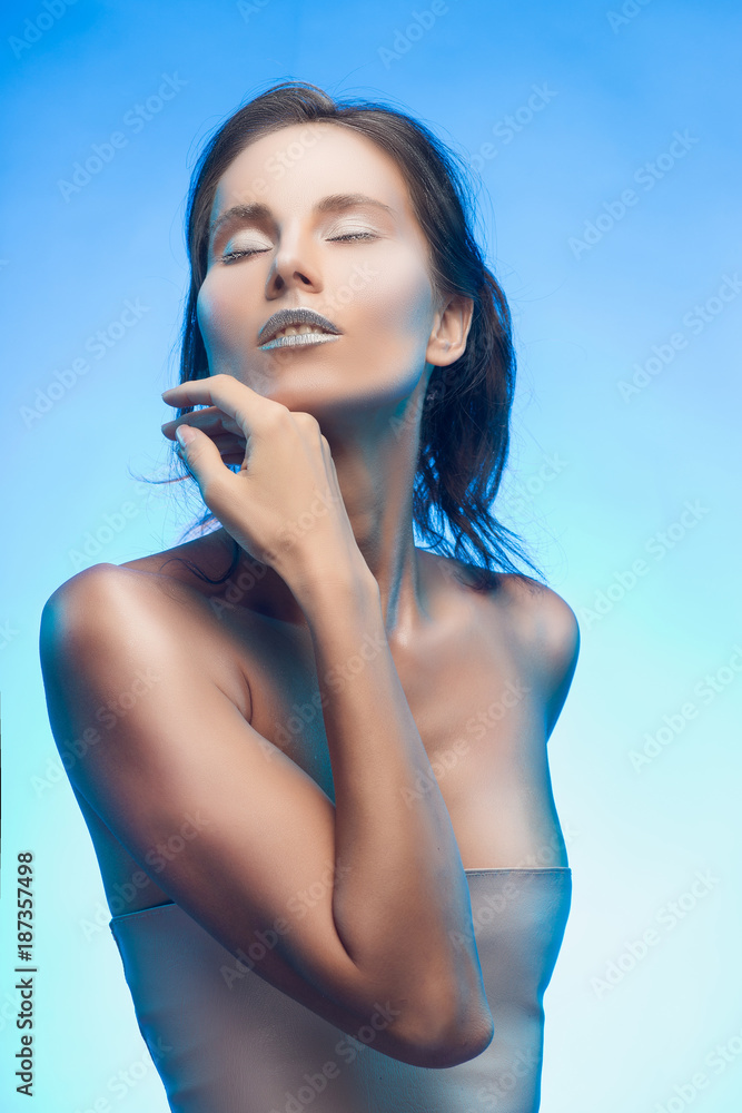 Beautiful tanned mixed asian-caucasian girl with silvery make-up. Beautiful tanned mixed asian-caucasian girl with silvery make-up.