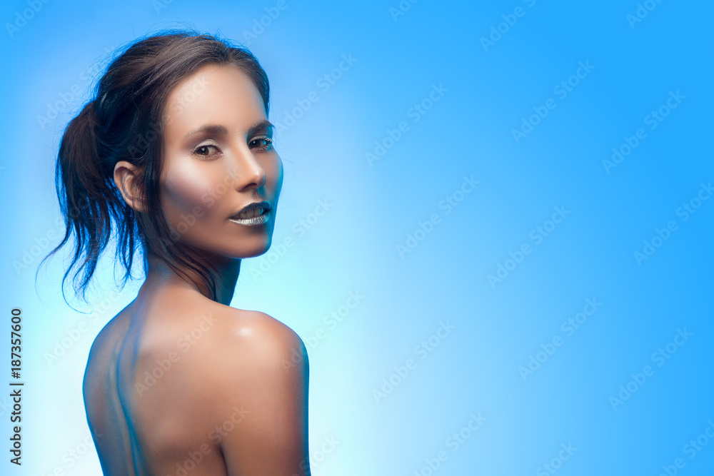 Beautiful tanned mixed asian-caucasian girl with silvery make-up.