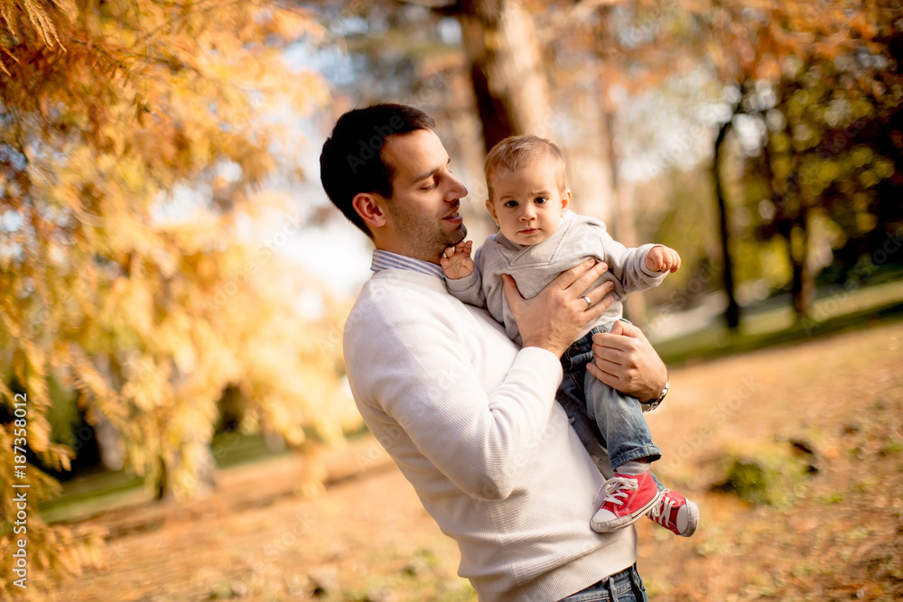 Fototapeta premium Young father and baby boy in autumn park