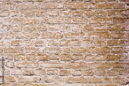 Wall of an old yellow brick. Textured surface for background.