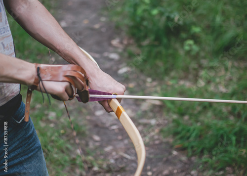 Archer tightening the arrow before shooting