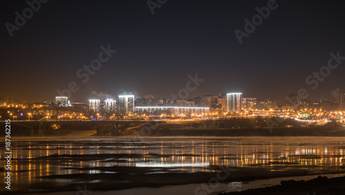 Evening view of city Ufa over White River covered with ice at winter  Russia.