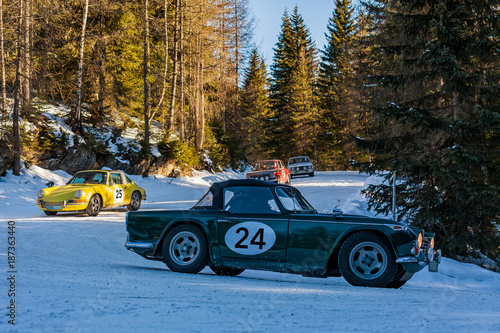 Vintage racing car driving classic rally on snow covert road © photoflorenzo