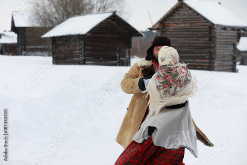 Couple in traditional winter costume of peasant in russia