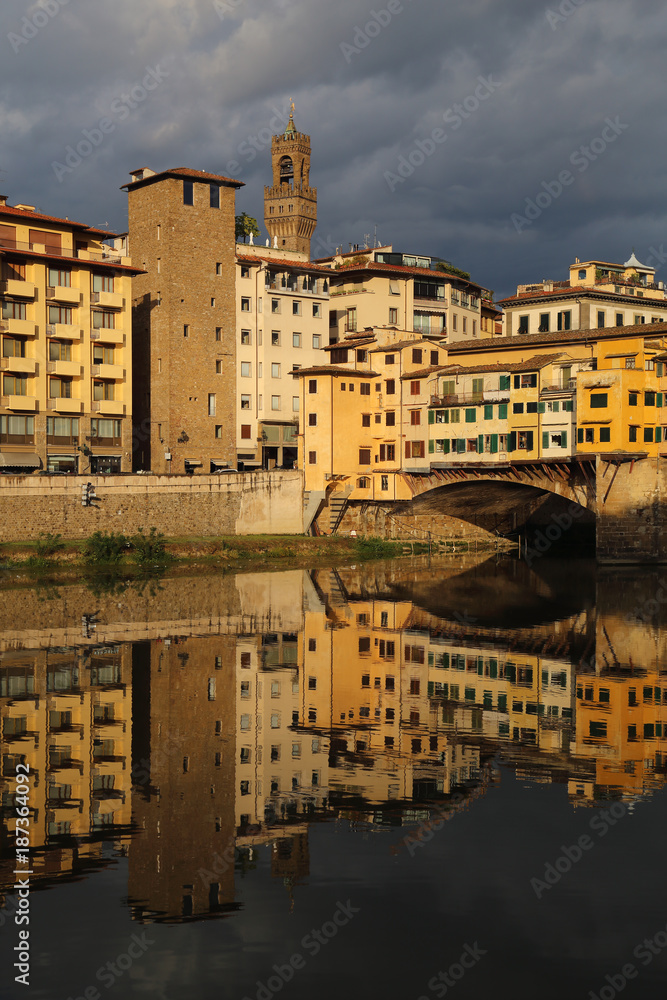 Historical buildings reflected in the Arno river in Florence, Italy