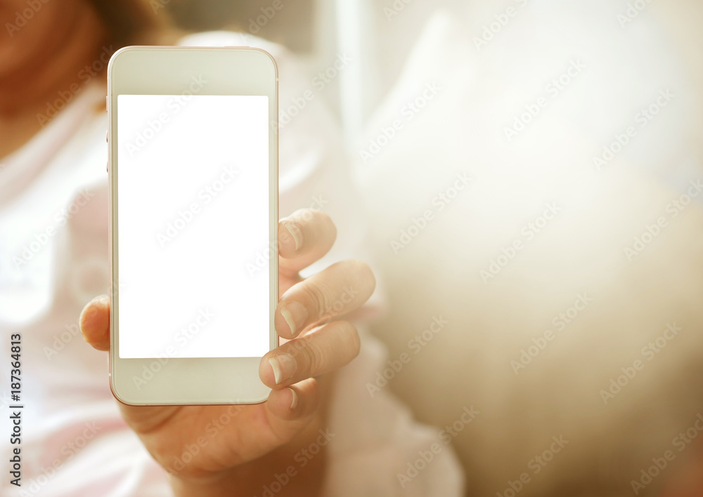 Women hands holding smart phone with blank screen. close up shot.vintage lighting effect.