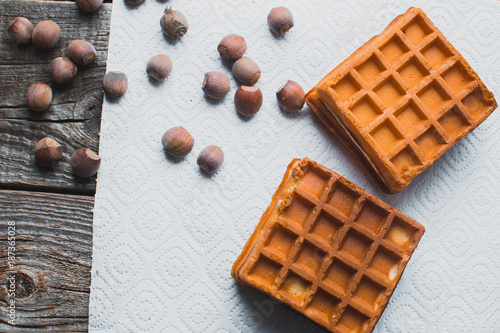 Waffle on a wooden background on a white napkin photo