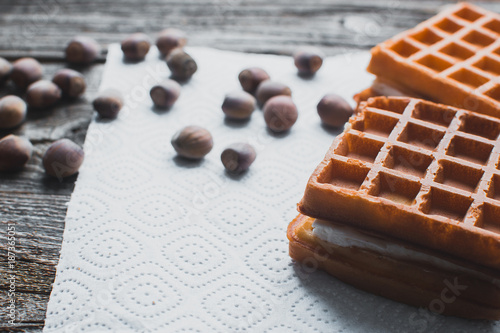 Waffle on a wooden background on a white napkin photo