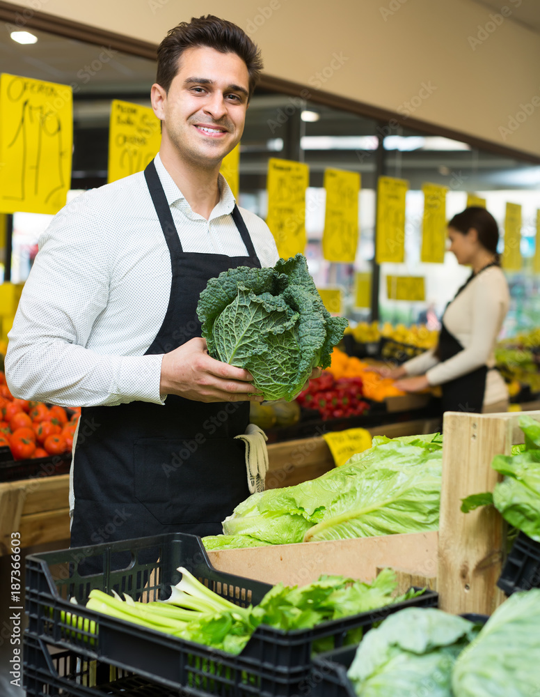 Fototapeta premium Seller with vegetables in market.