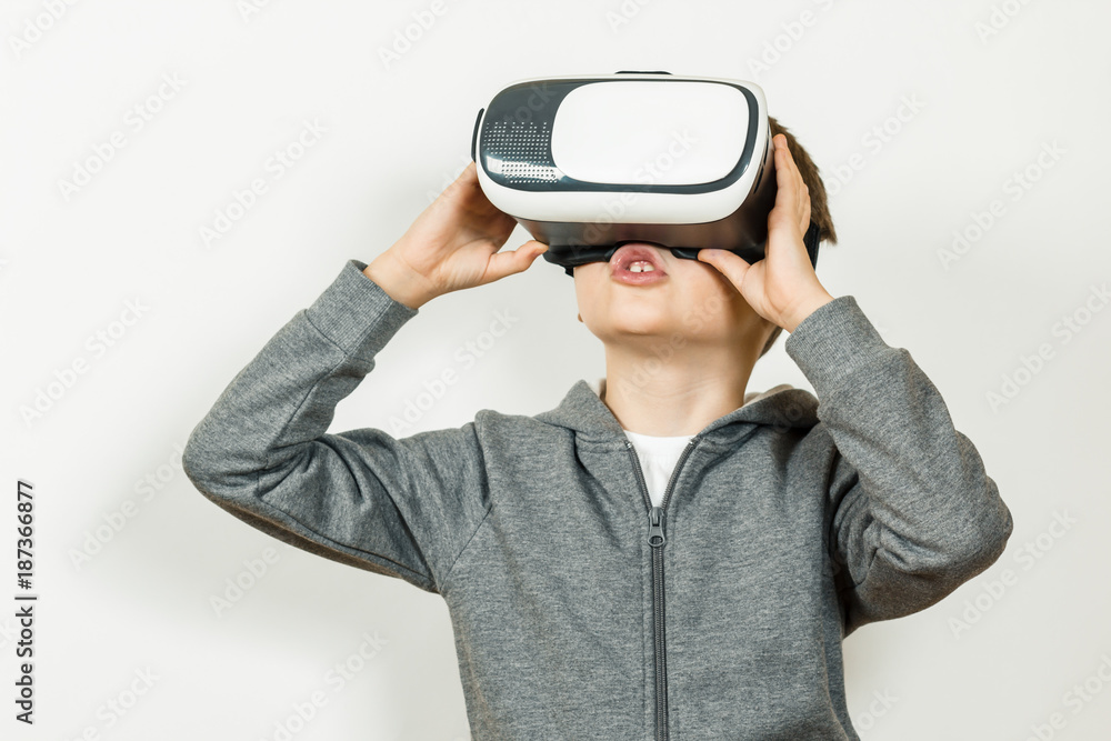 Boy with a headset of virtual reality. Innovative technology. On an white background Boy with a headset of virtual reality. Innovative technology. On an white background