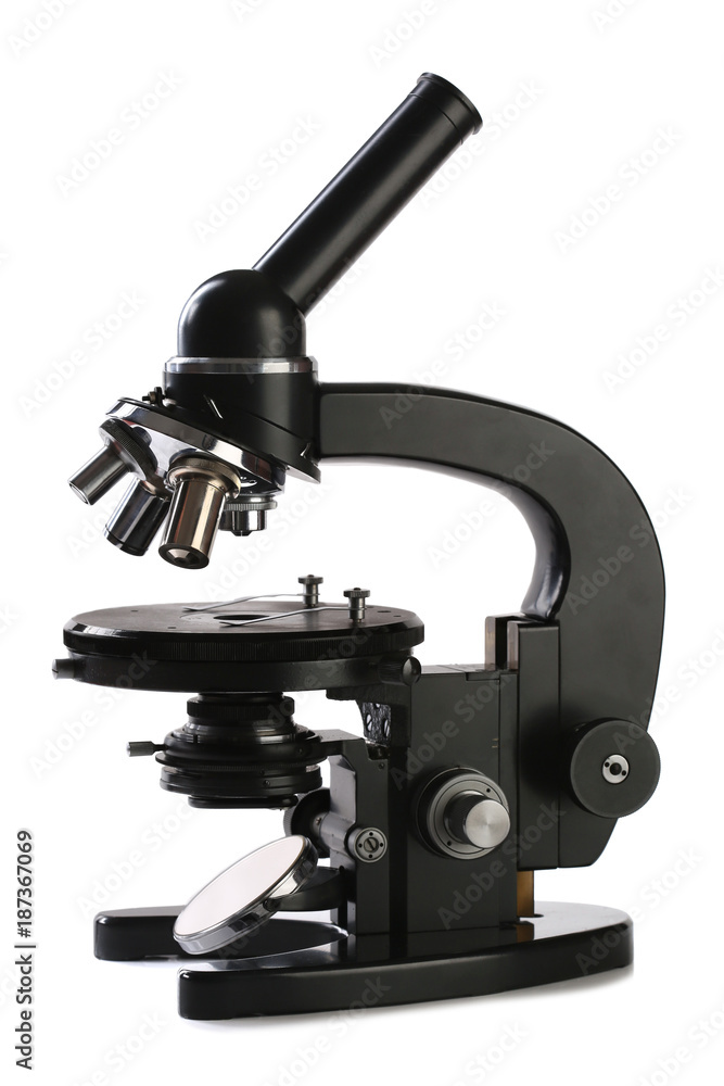 Old black microscope isolated on white Old black microscope isolated on white