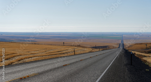 Highway through rolling golden farmland