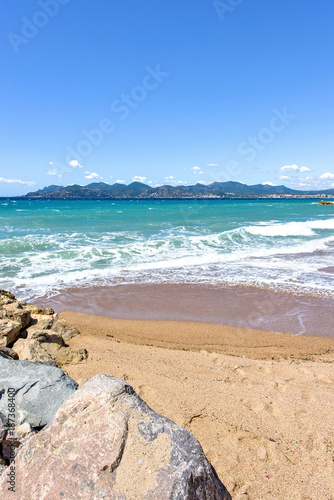 Daylight sunny view from rocks to blue sea and mountains © frimufilms