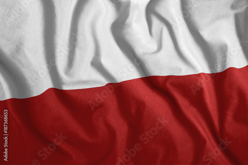 The Polish flag is flying in the wind. Colorful, national flag of Poland. Patriotism, a patriotic symbol.