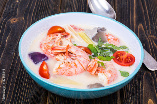 Delicious hot Thai soup Tom Yam with coconut milk and shrimps