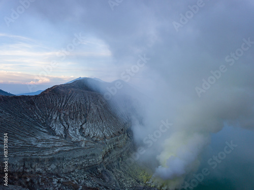 Aerial view from drone to Kawah Ijen volcano crater with sulfur fume. Ijen crater the famous tourist attraction near Banyuwangi, East Java, Indonesia