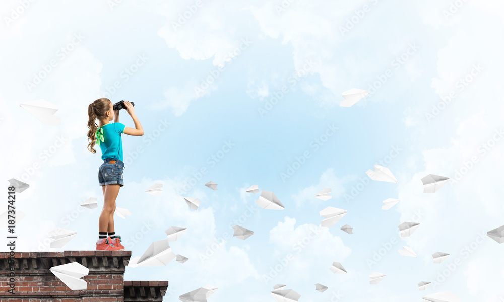 Concept of careless happy childhood with girl of school age looking in future Concept of careless happy childhood with girl of school age looking in future