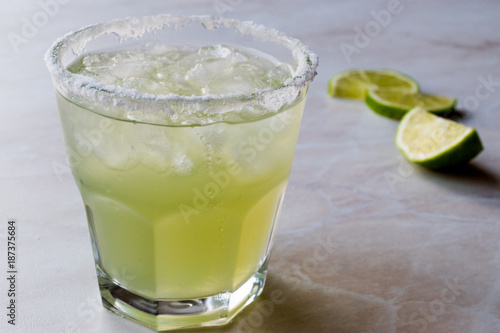 Classic Margarita Cocktail in Salted Glass with Lime and Crushed ice.