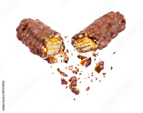 Waffle chocolate bar with nuts broken into two parts close up, isolated on white background