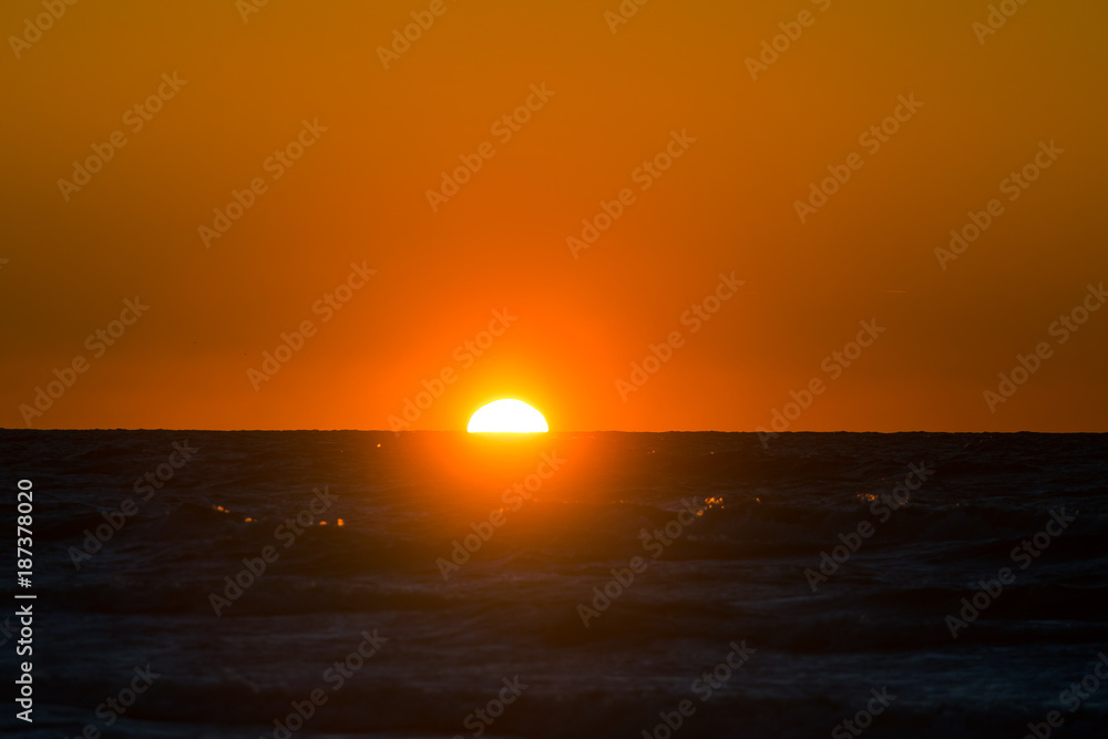 A beautiful, colorful sunset at the Baltic sea beach. Vivid natural scenery.